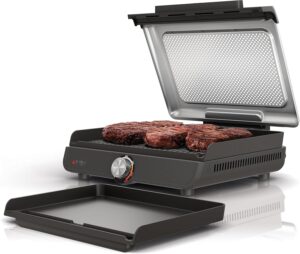 Ninja Sizzle GR101UK indoor electric grill with ridged plate cooking steak on UK kitchen worktop — best grill UK 2026